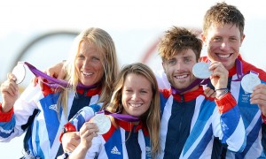 Great Britain's silver medallists in the women's and men's sailing 470 two-person dinghy (from L) Saskia Clark, Hannah Mills, Luke Patience and Stuart Bithell smile on the podium at the London 2012 Olympic Games in Weymouth on August 10, 2012. AFP PHOTO / William WESTWILLIAM WEST/AFP/GettyImages